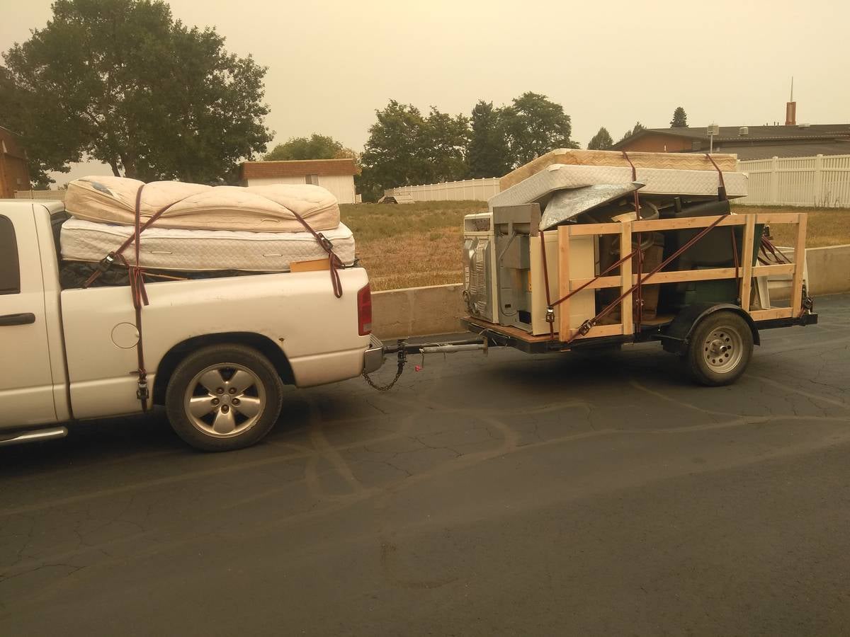 HM Demo and Hauling Dodge Ram truck and trailer loaded with mattresses and furniture